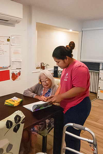 image of staff member assisting a resident with a craft activity